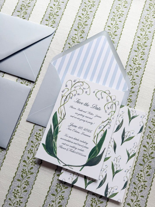 Wedding invitation with floral design on a patterned surface