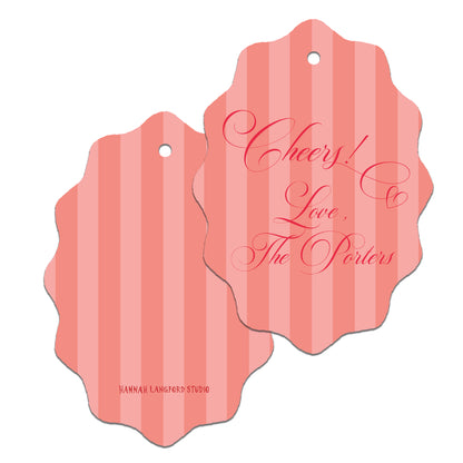 Two pink striped gift tags with decorative text on a white background