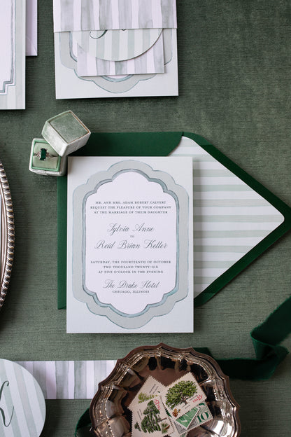 Invitation card with green envelope on a textured surface