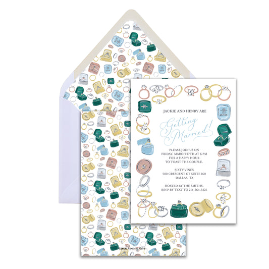 Wedding invitation set with rings and jewelry design on a white background