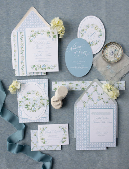 Collection of wedding invitations and stationery items on a gray background