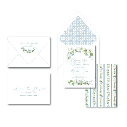 Invitation with blue florals and a patterned envelope on a white background