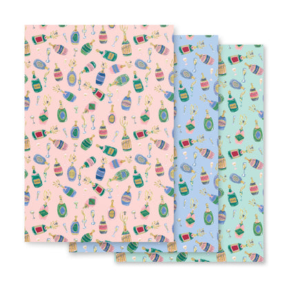A set of three sheets of gift wrapping paper with a colorful pattern that includes images of champagne, and other festive items.