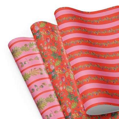 Pink and orange wrapping paper with illustrations of leaves, fruit, and acorns.