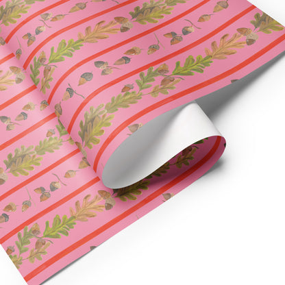 Pink and orange wrapping paper with illustrations of leaves, fruit, and acorns.