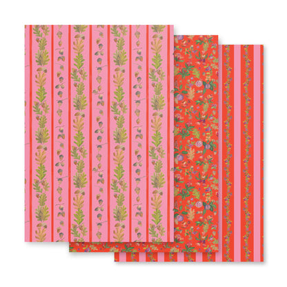 Pink and orange wrapping paper with illustrations of leaves, fruit, and acorns.