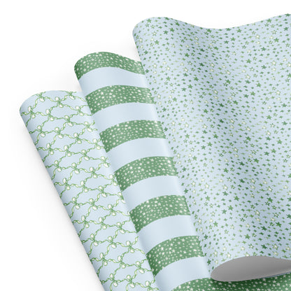 wrapping paper with green and blue illustrations of stars and bows.