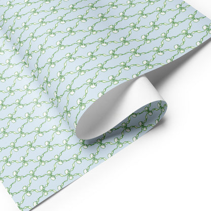 wrapping paper with green and blue illustrations of stars and bows.